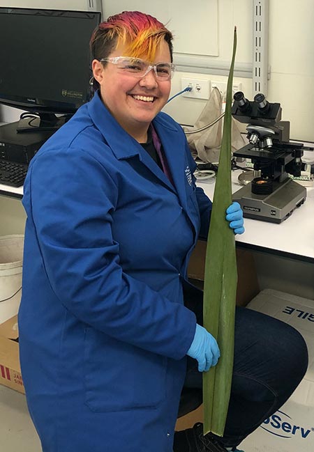 Jaye Barclay holding a harakeke leaf 